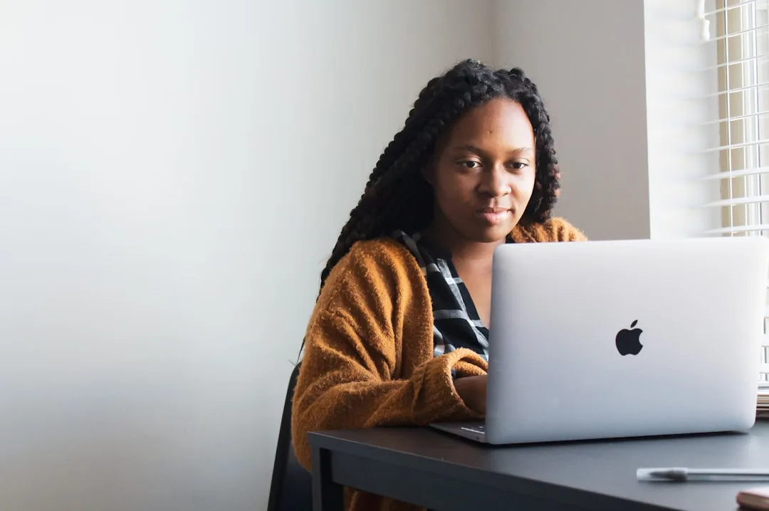Small business owner at a laptop with a draft blog post