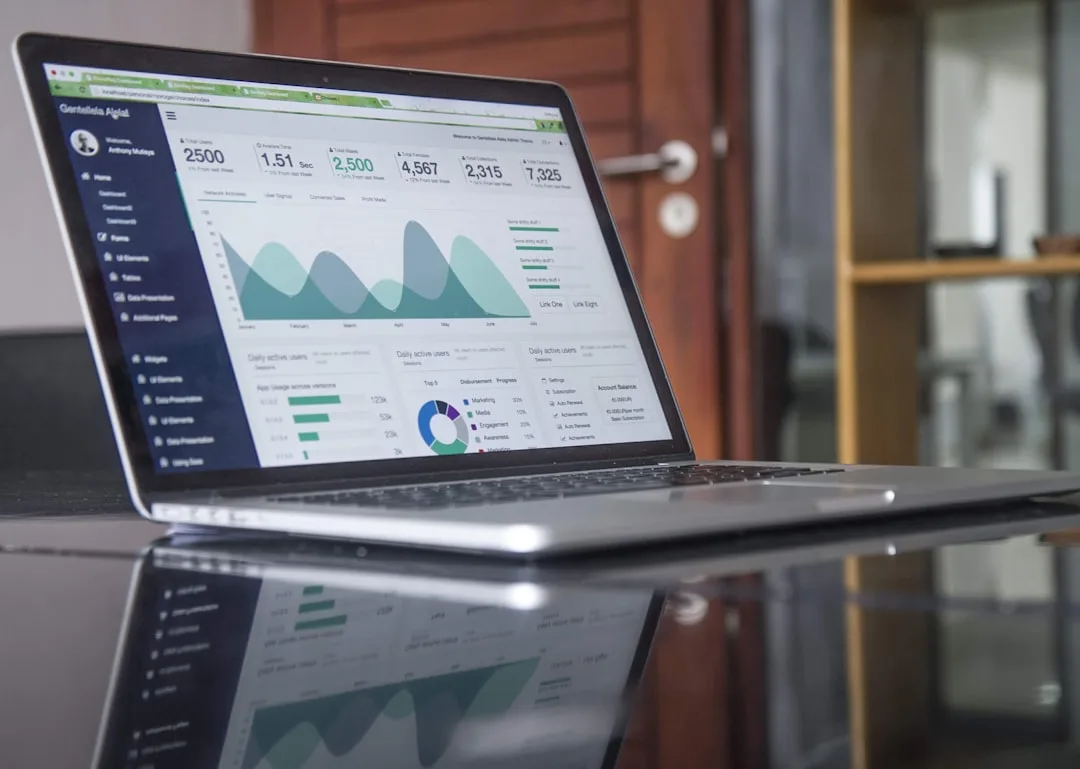 Laptop screen showing website service pages and analytics charts