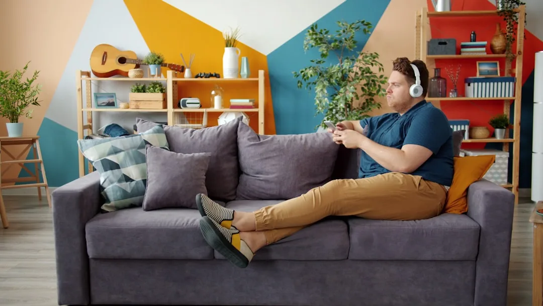 Person using smartphone on couch