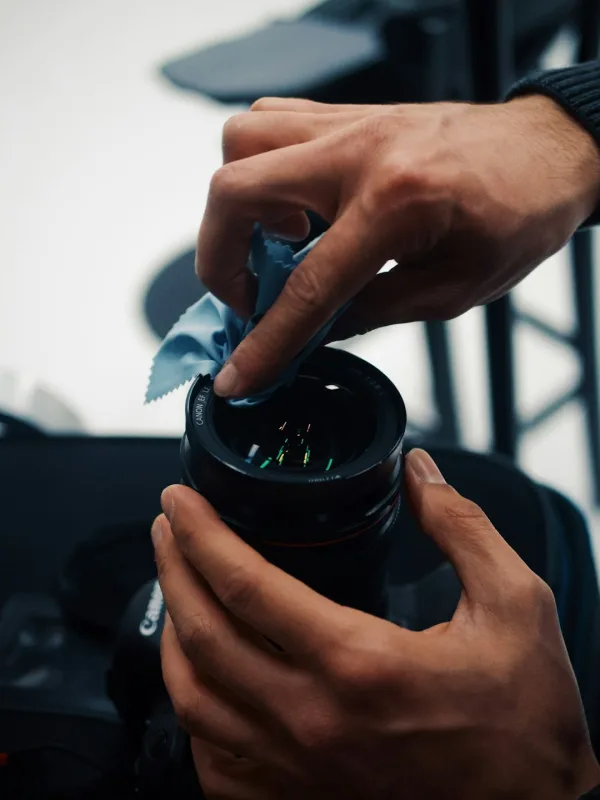 technician cleaning ps5 disc with microfiber cloth
