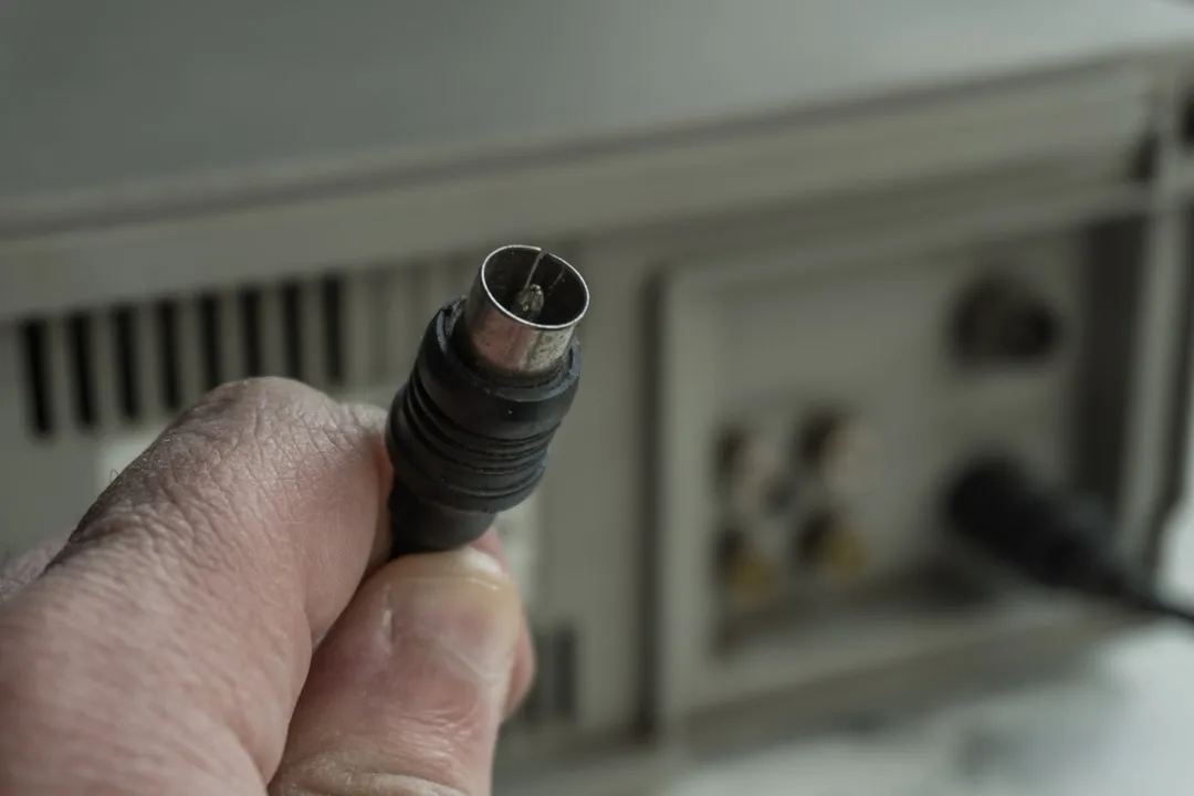 hand holding damaged hdmi cable connector
