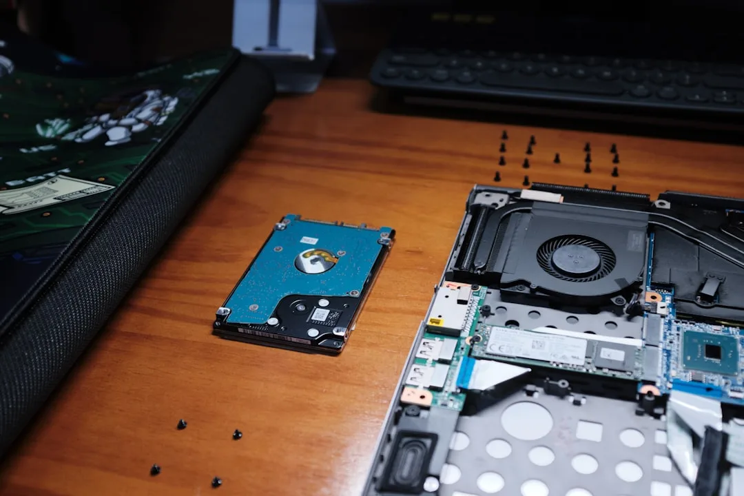 Technician upgrading laptop SSD drive