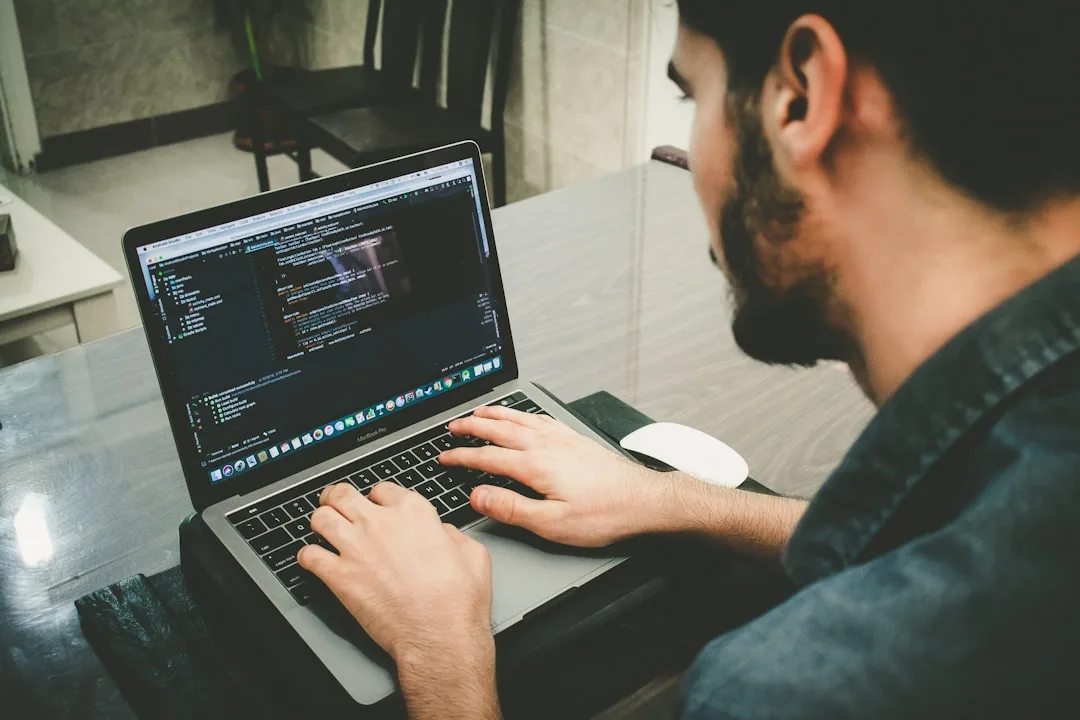 technician comparing website code on laptop screen