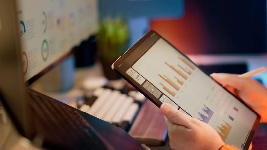 developer holding smartphone showing website analytics dashboard