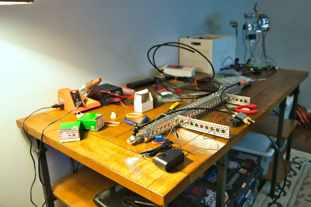 workbench with router and network cables beside laptop