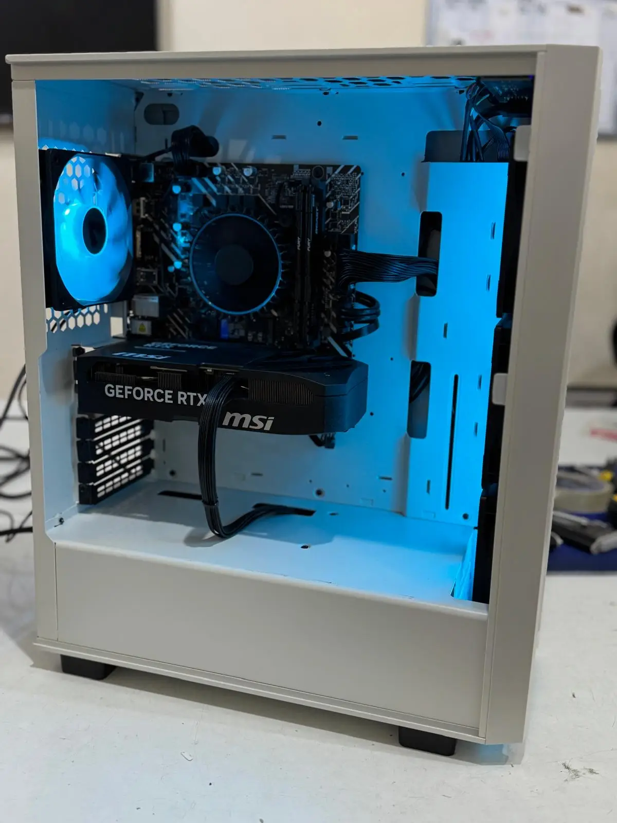 Minimal white PC build with blue lighting and clean internal cable management