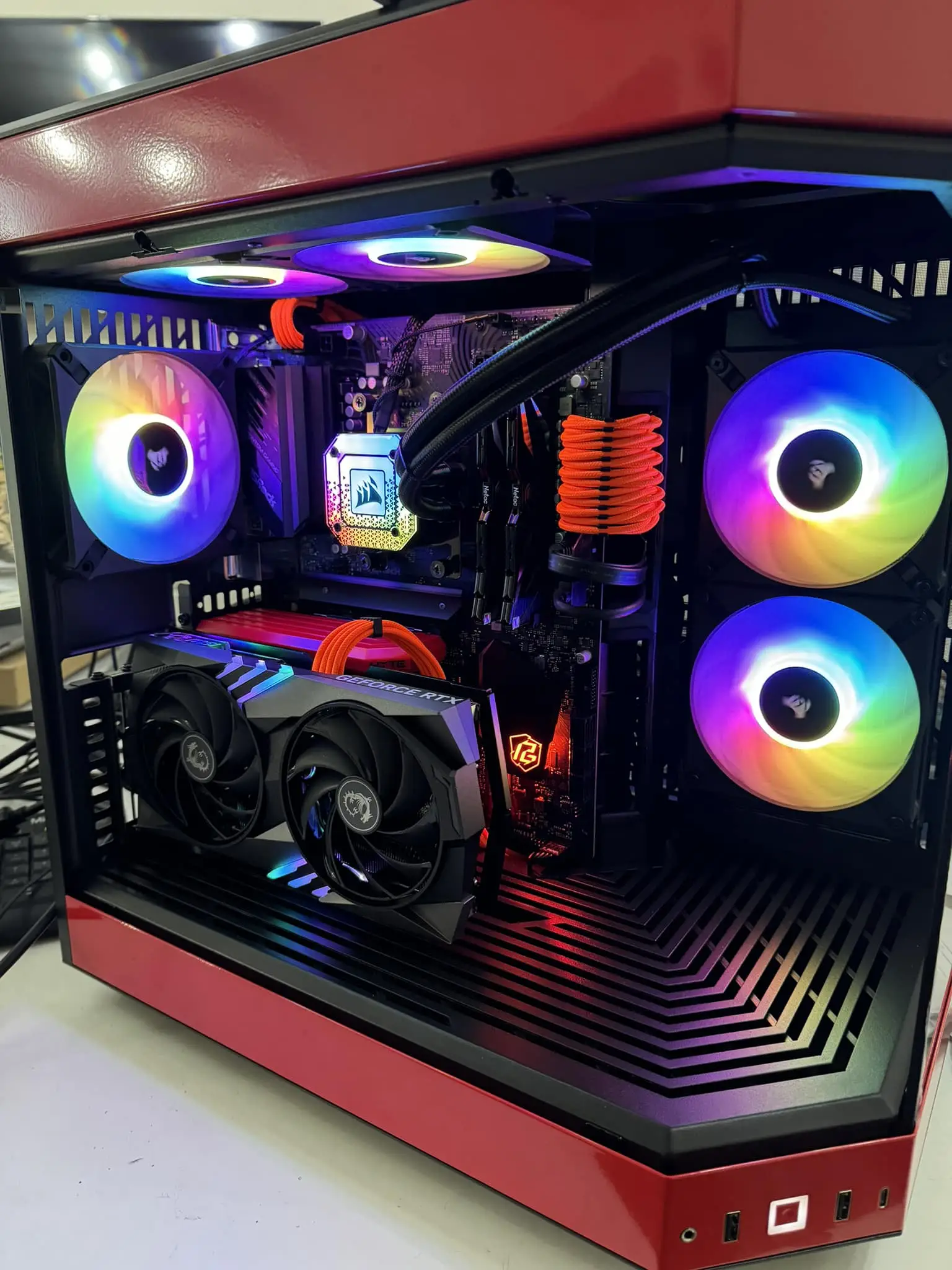 Red and black RGB gaming PC with liquid cooling and dual front intake fans